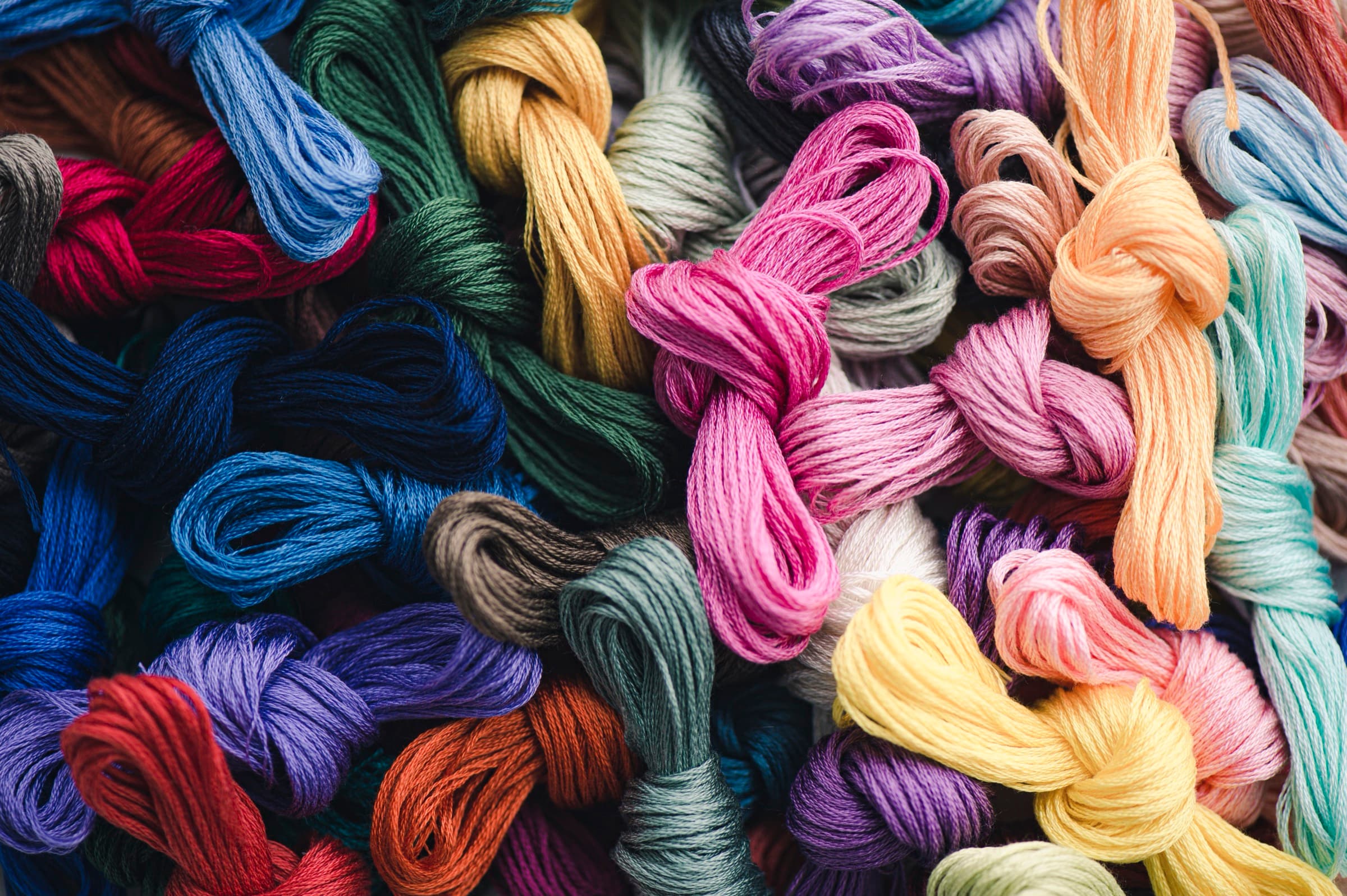 Close-up of colorful COSMO embroidery floss skeins piled together