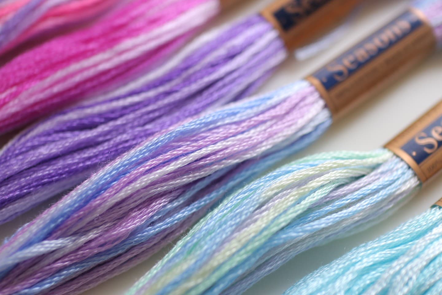 COSMO Seasons variegated embroidery floss skeins in blues, greens, purples, and pinks