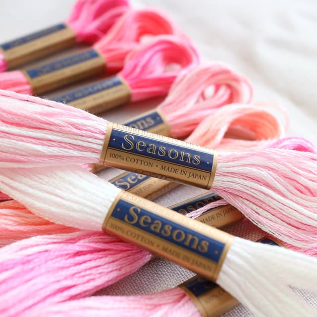 COSMO Seasons variegated floss skeins in soft pink and white gradations