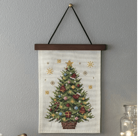 Christmas tree cross-stitch displayed on a wooden embroidery wall hanger