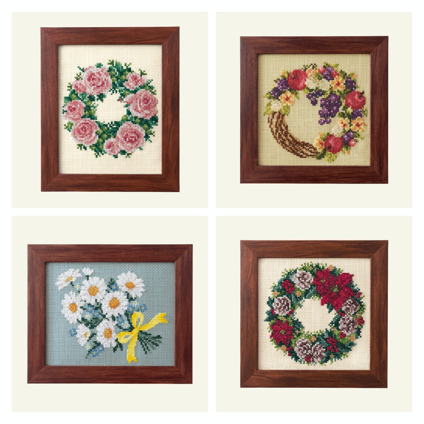 Four framed floral wreaths including roses, harvest fruit, daisies, and poinsettia