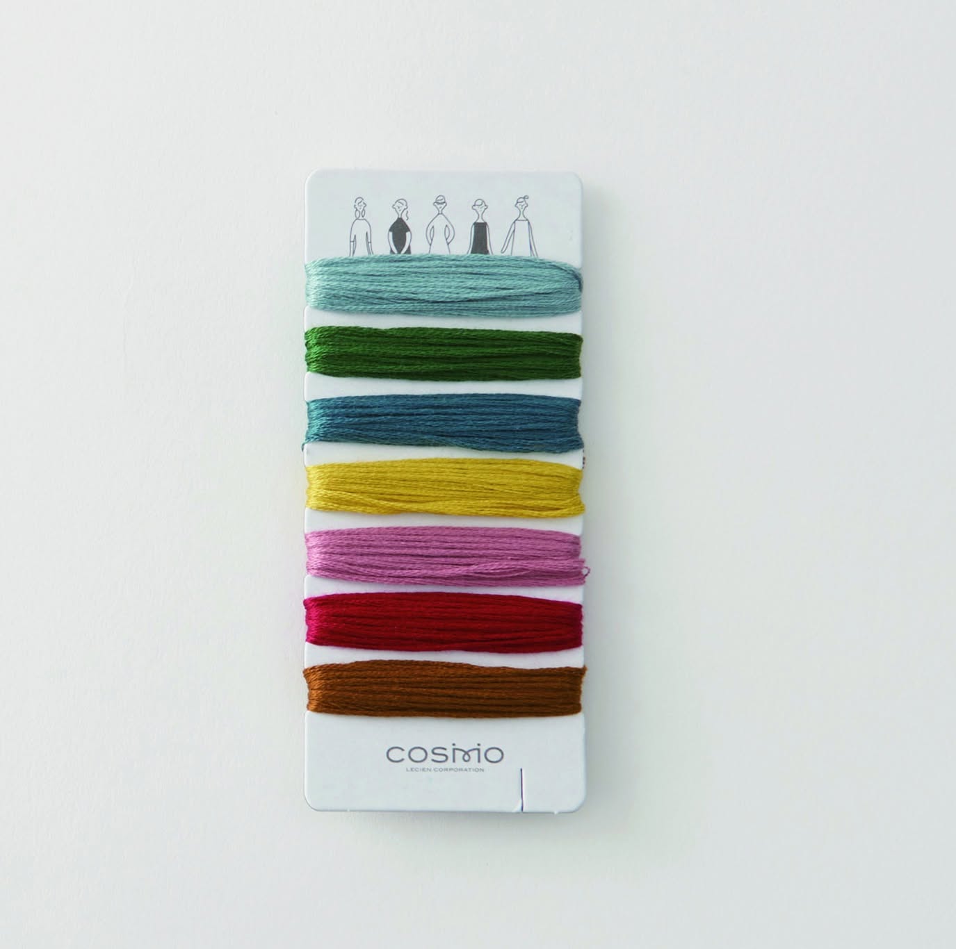 Curated COSMO palette card with a seven-band solid floss wrap on white board