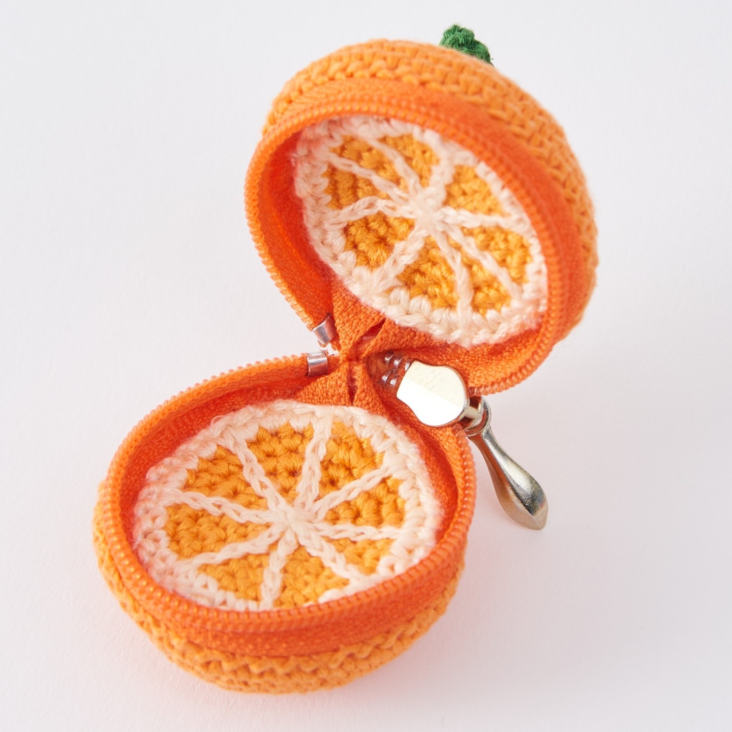 Open orange pouch crocheted with COSMO embroidery floss, segment lining and zipper visible