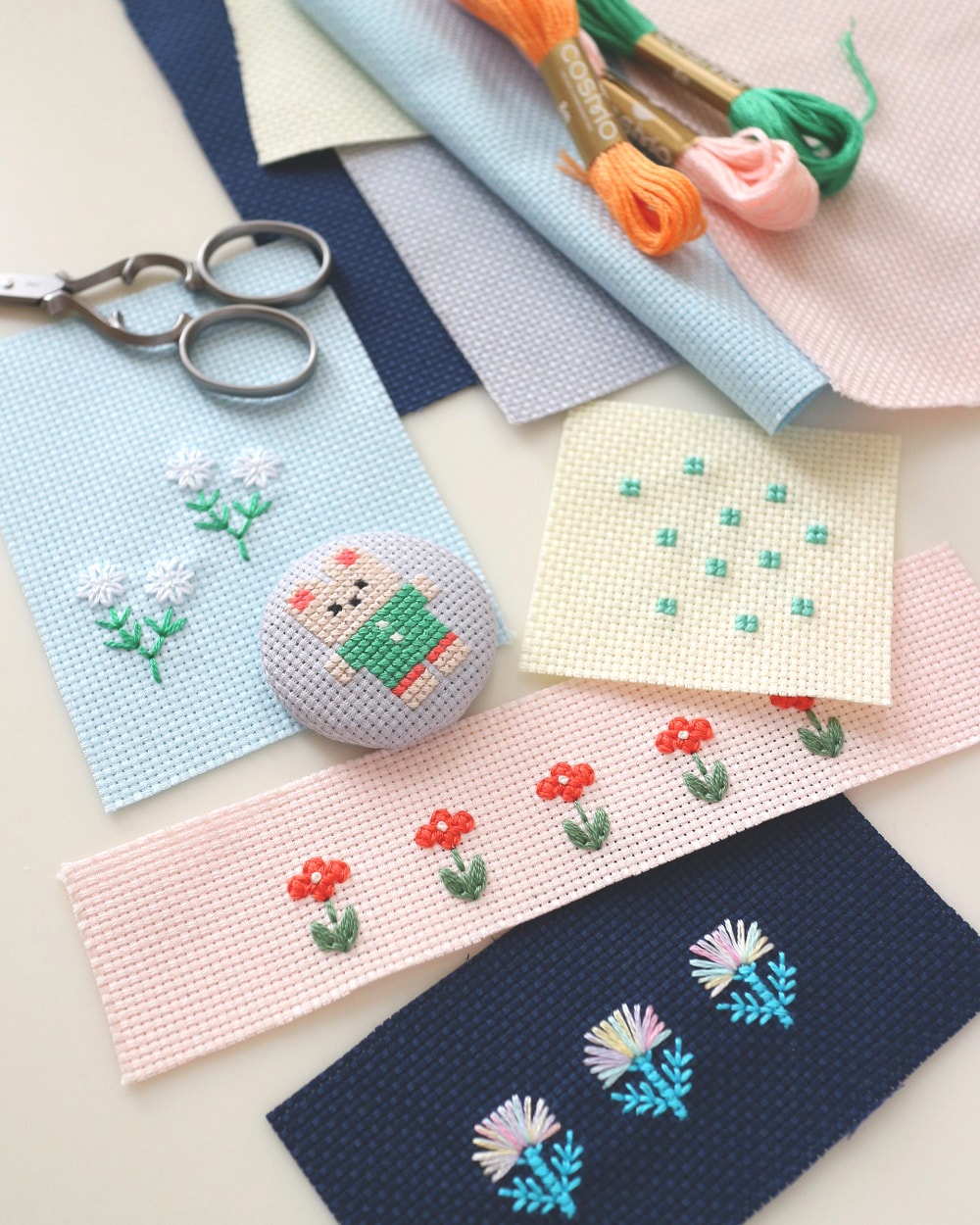 Beginner embroidery practice samples with COSMO orange pink and green skeins
