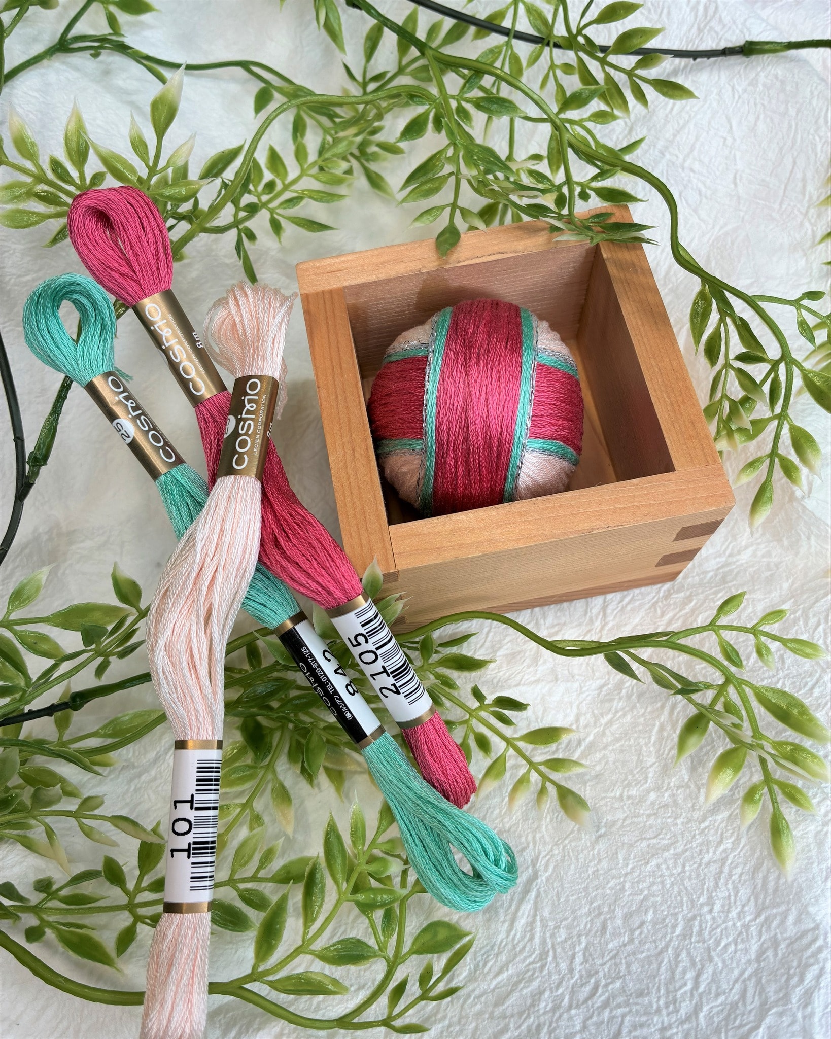Colorful temari ball nestled in a wooden masu box