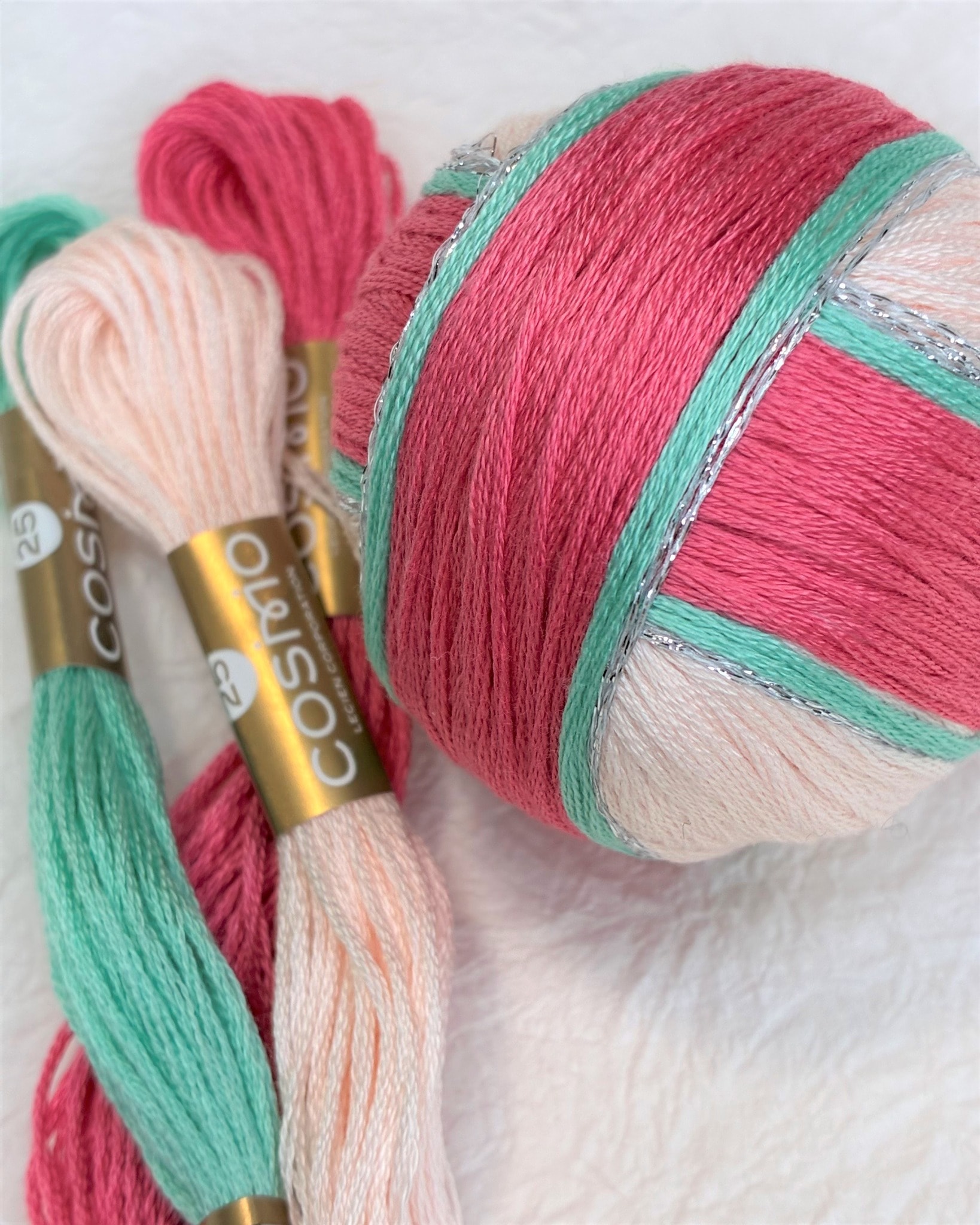 COSMO floss skeins beside a temari ball in a wooden box