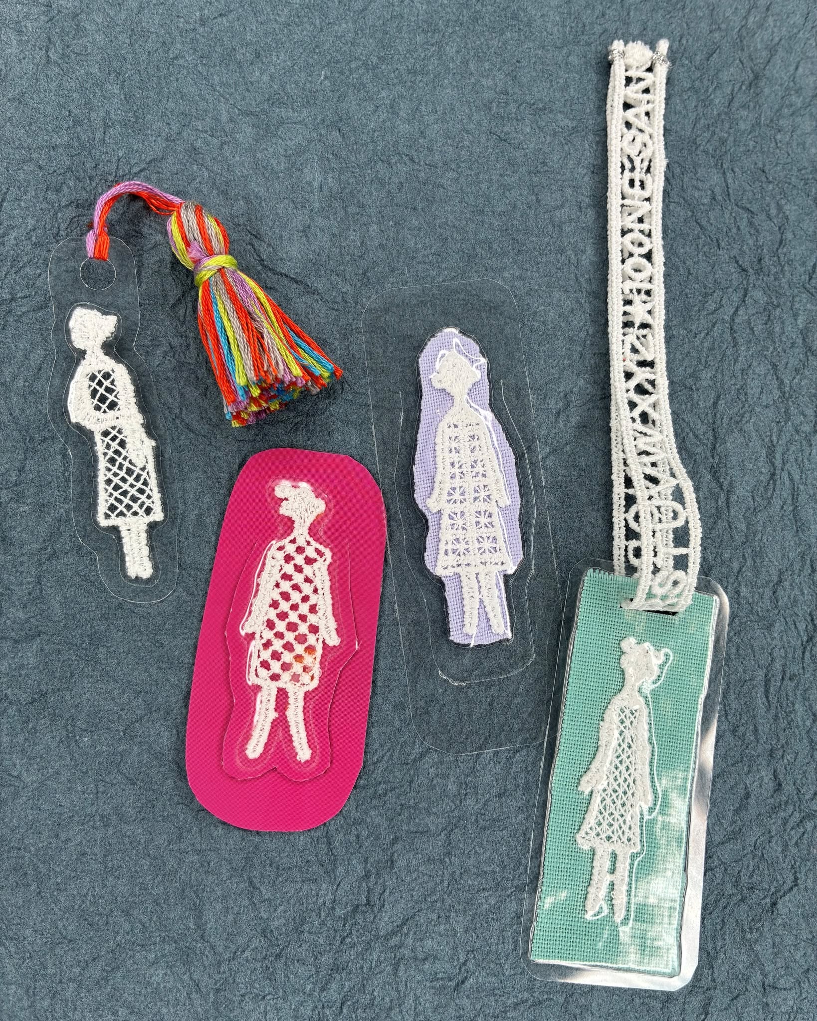 Lace figure bookmarks with multicolor floss tassel and pastel backgrounds