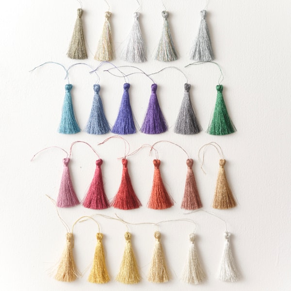 Handmade metallic tassels in gold, silver, blue, purple, rose, and green — made with Nishiki thread
