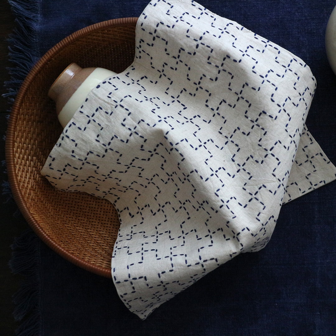 Cream kaki-no-hana sashiko cloth draped on a basket