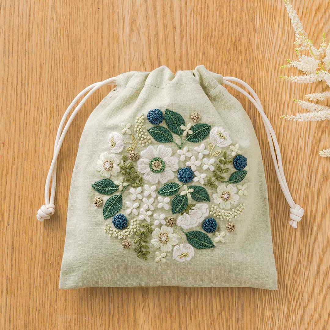 Sage drawstring pouch with cream blooms and navy French-knot berries