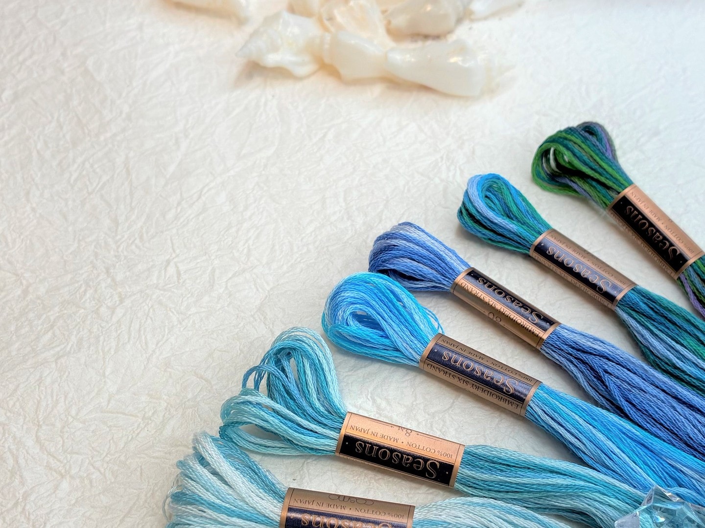 COSMO Seasons variegated floss in blues and greens with clear color gradation along each strand