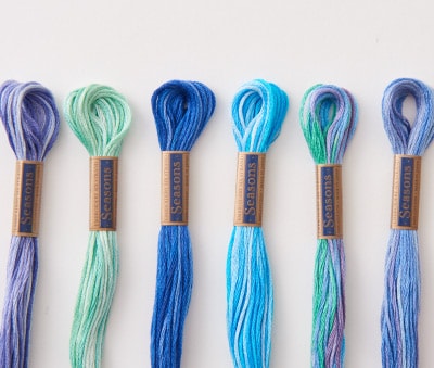 COSMO Seasons 5000 variegated embroidery floss skeins in cool blues, greens, and purples