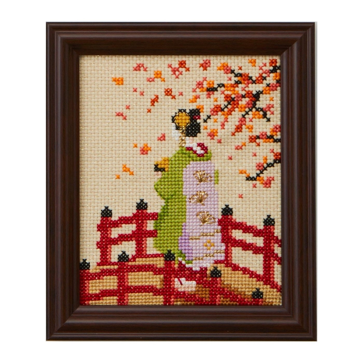 Framed cross-stitch of a figure in kimono on a red bridge among autumn leaves