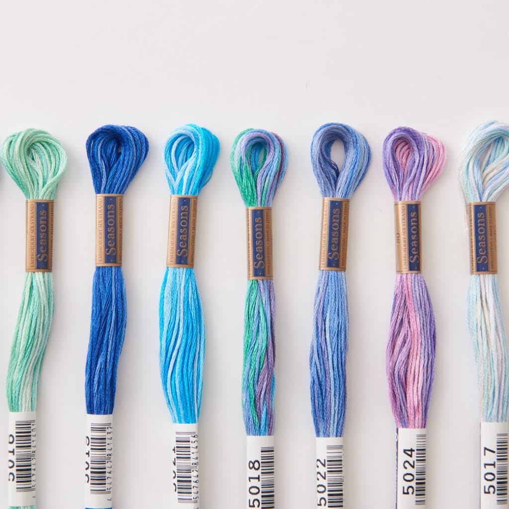 COSMO Seasons 5000 variegated embroidery floss skeins in blues, greens, and purples