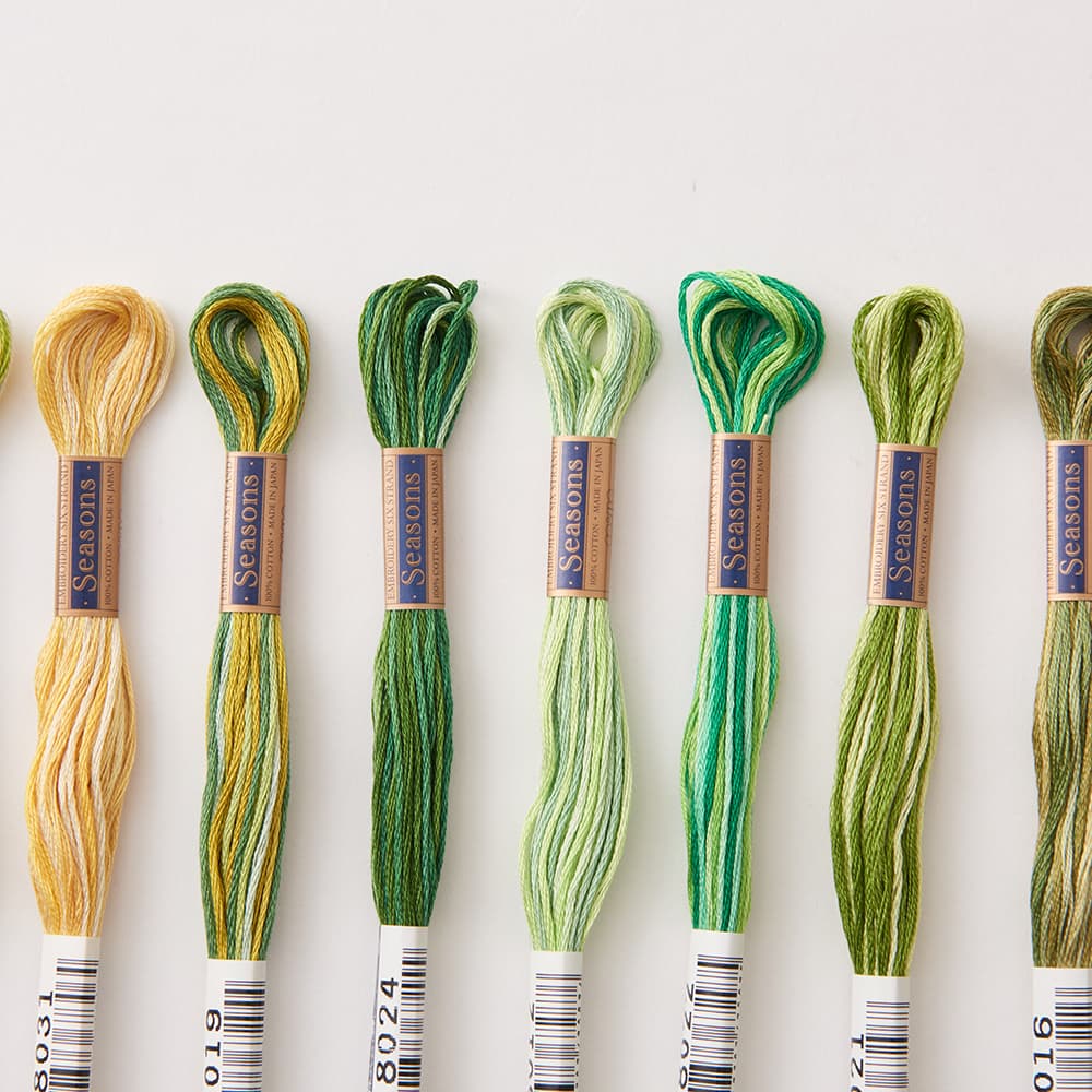 COSMO Seasons 8000 variegated embroidery floss skeins in greens and yellow-greens