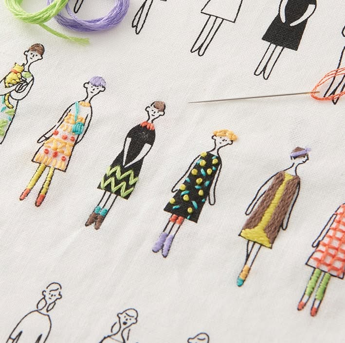 100 Ladies–style printed figures on white fabric partially filled with colorful COSMO embroidery floss