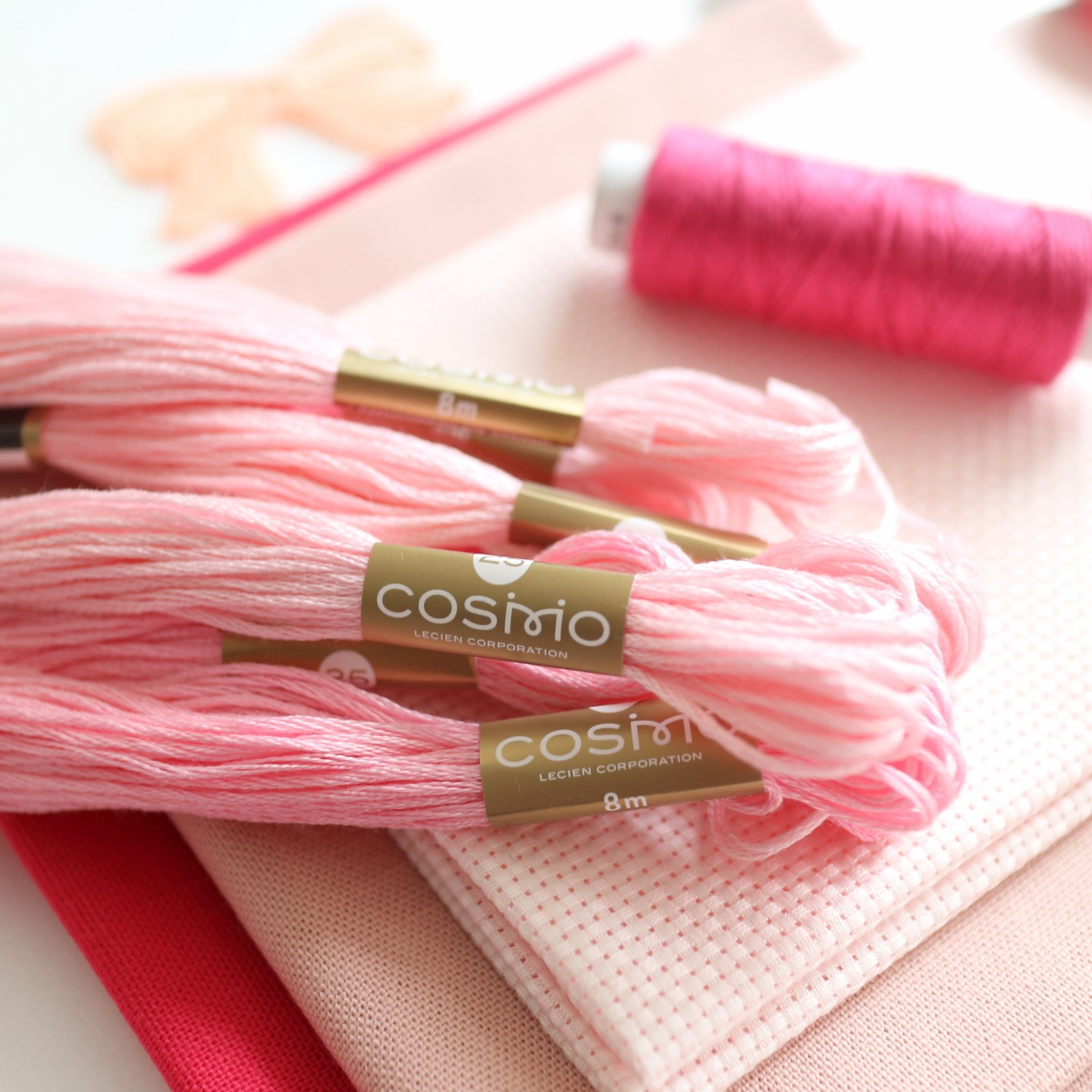 COSMO embroidery floss and related craft materials arranged for color planning