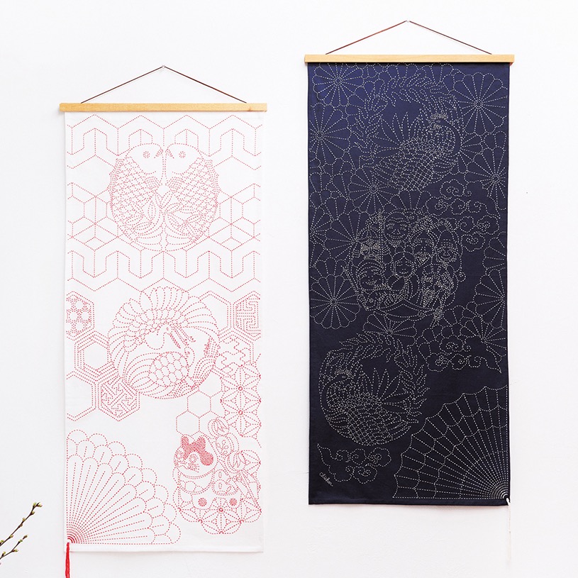 Pair of sashiko wall hangings with crane, fan, and geometric motifs