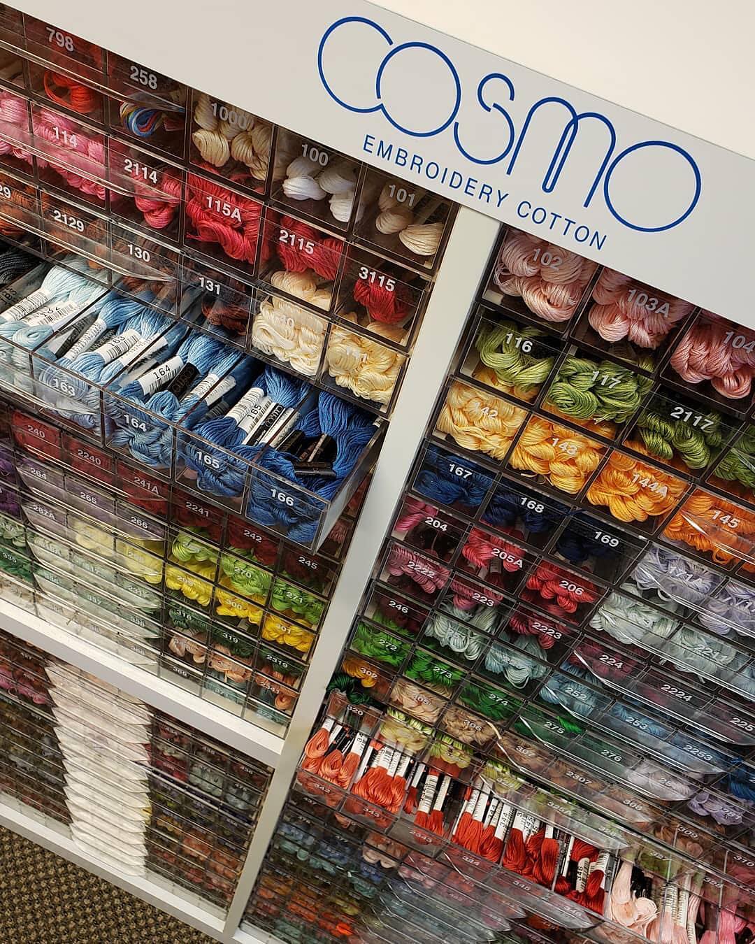 Retail bins filled with color-sorted COSMO embroidery floss skeins