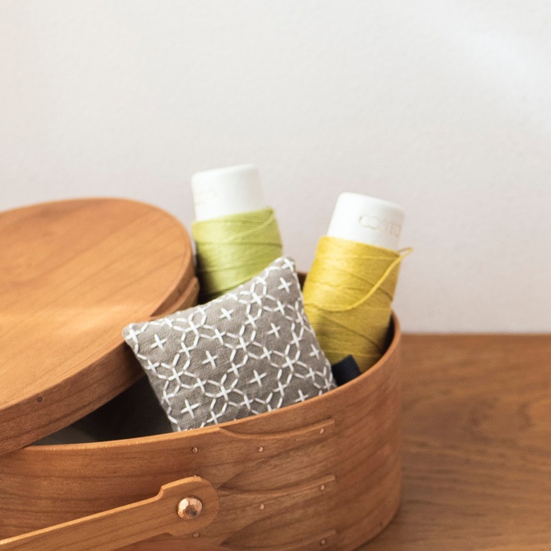 Wooden shaker box with COSMO mini cones and a white sashiko pincushion