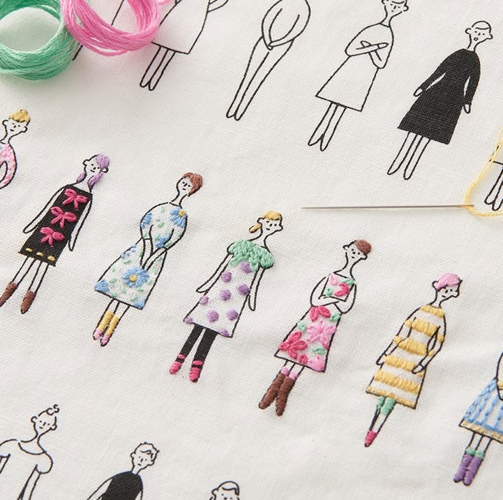 COSMO embroidery floss cards with figures and a threaded needle