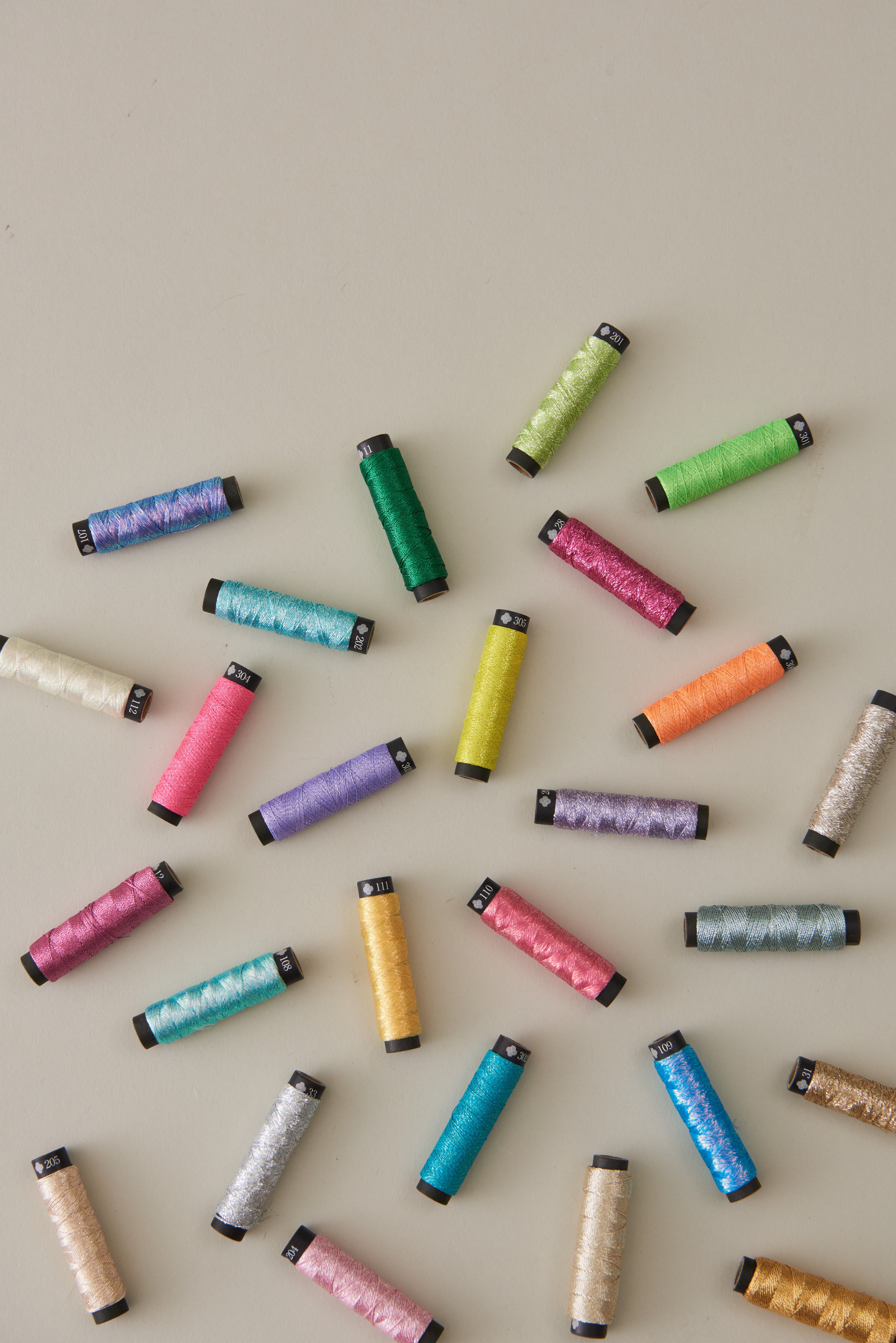 COSMO Nishikiito metallic embroidery thread spools in a full product arrangement